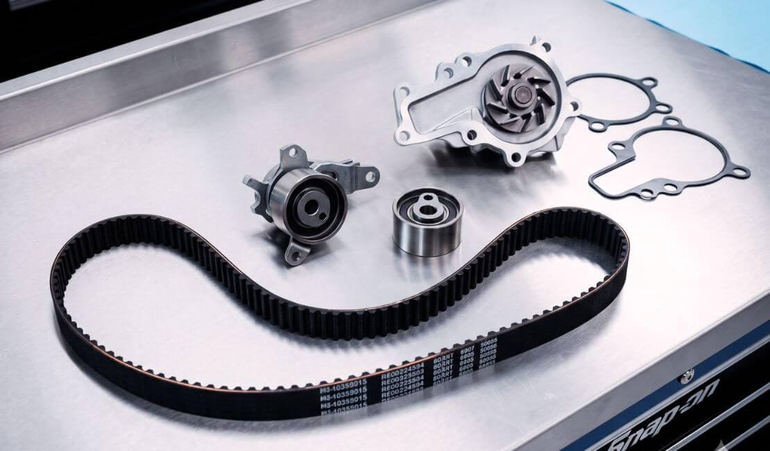 Complete timing belt kit including belt, tensioner, idler pulley, and water pump at Grays Automotive